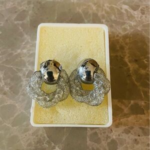 Elegant Earrings with twisted design, silver tone, and sparkly accents.